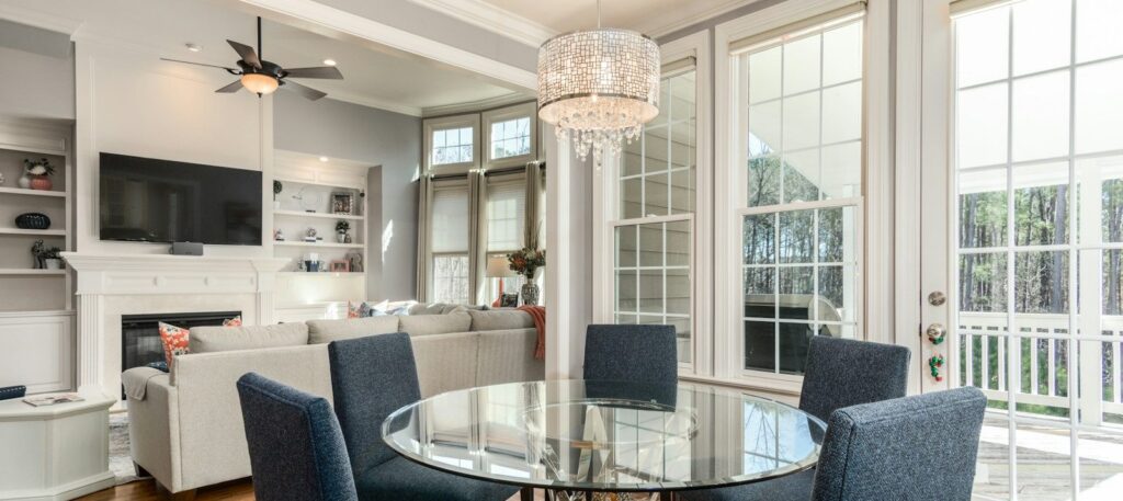 round clear glass-top table and five gray chairs dining se